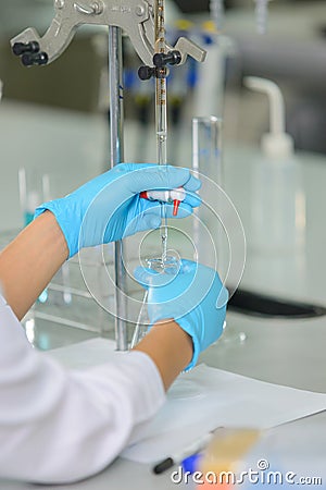 The woman whoâ€™s the scientist is demonstrate the titration technique Stock Photo